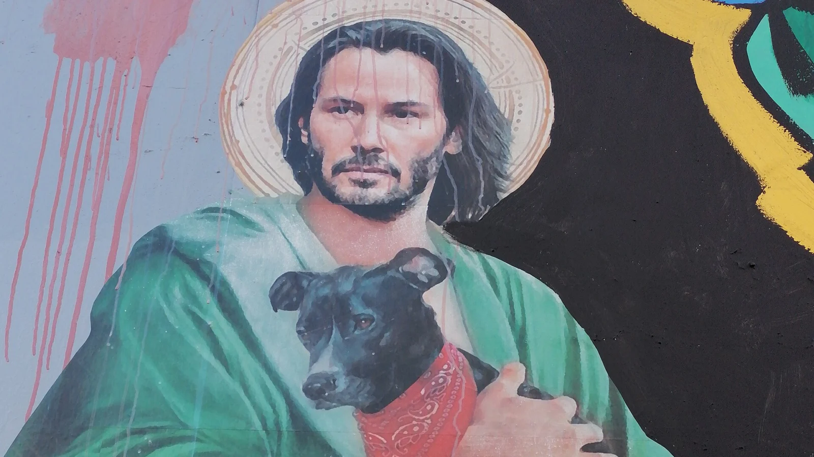 Keanu Reeves representado como "Jesucristo" con un perro negro símbolo de las protestas sociales en Santiago de Chile.
